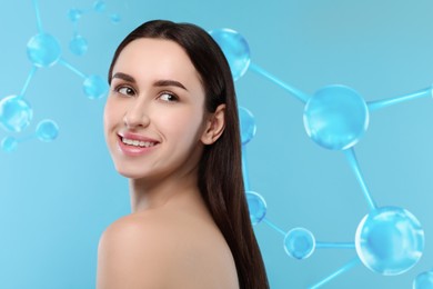 Beautiful woman with perfect healthy skin and molecular model on light blue background. Innovative cosmetology