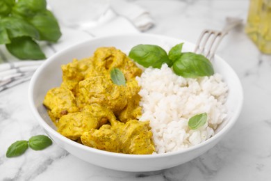 Photo of Delicious rice and chicken with curry sauce on white marble table, closeup