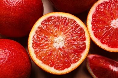 Photo of Closeup view of fresh ripe red oranges on table