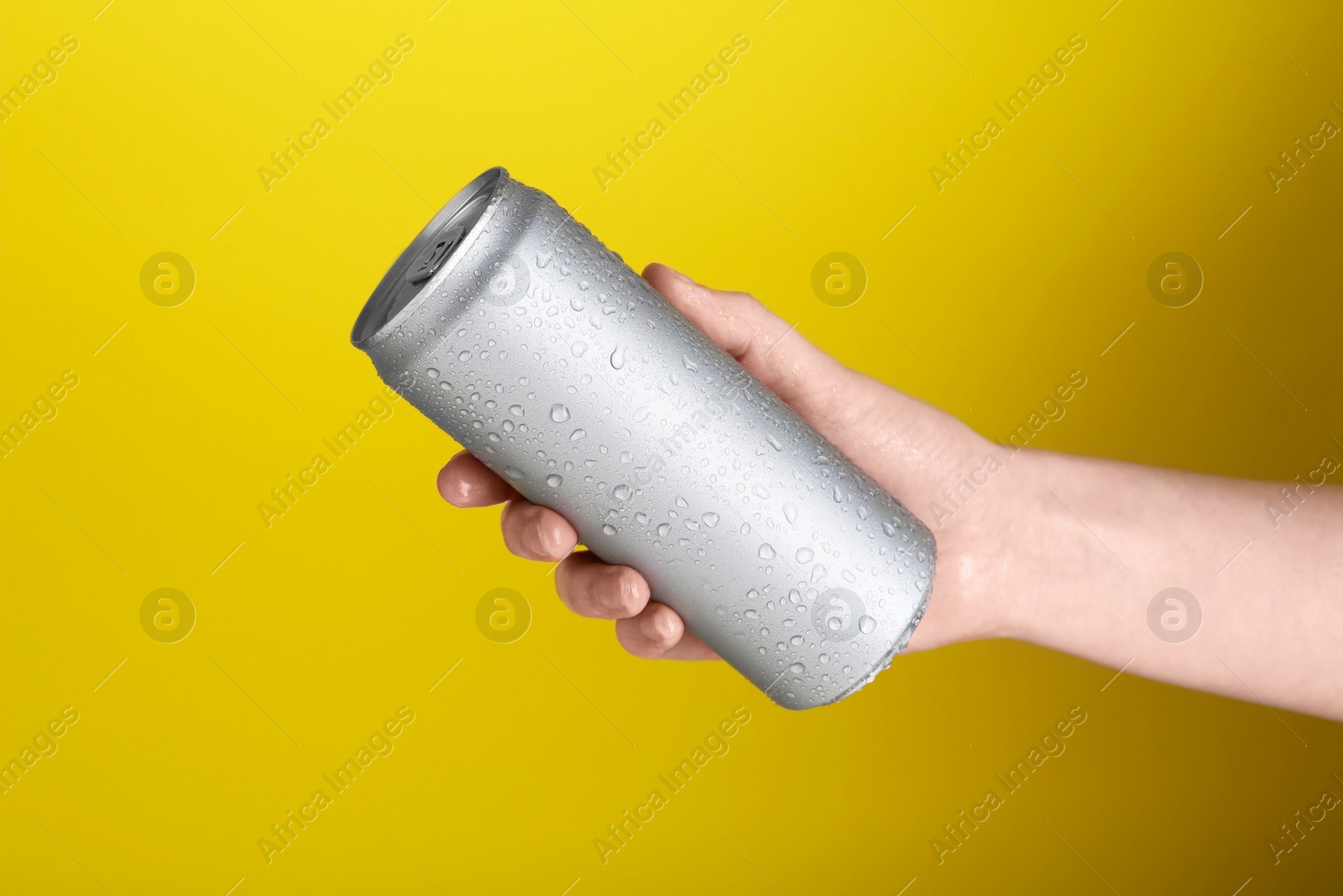 Photo of Woman with energy drink on yellow background, closeup