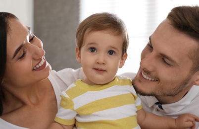 Happy family with adorable little baby at home