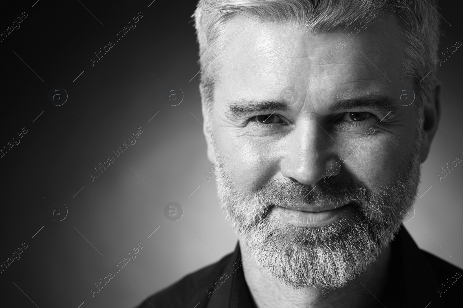 Photo of Portrait of handsome man on dark background, space for text. Black and white effect