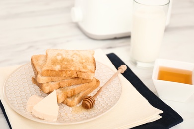 Photo of Delicious breakfast with fresh toasts on kitchen table, closeup