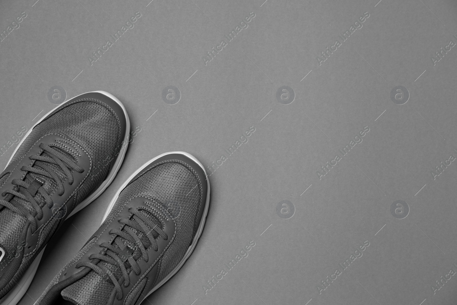 Photo of Pair of stylish sport shoes on grey background, flat lay. Space for text