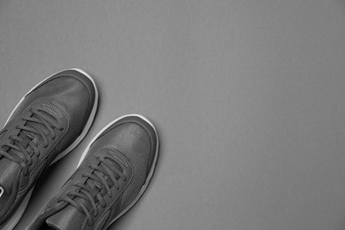 Pair of stylish sport shoes on grey background, flat lay. Space for text