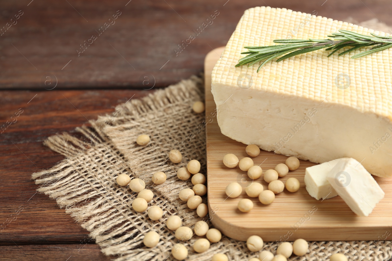 Photo of Delicious tofu with rosemary and soy on wooden table, closeup. Space for text