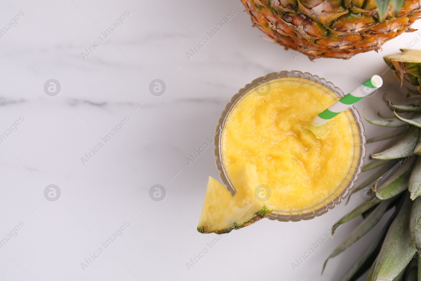 Photo of Tasty pineapple smoothie and fruits on white marble table, flat lay. Space for text