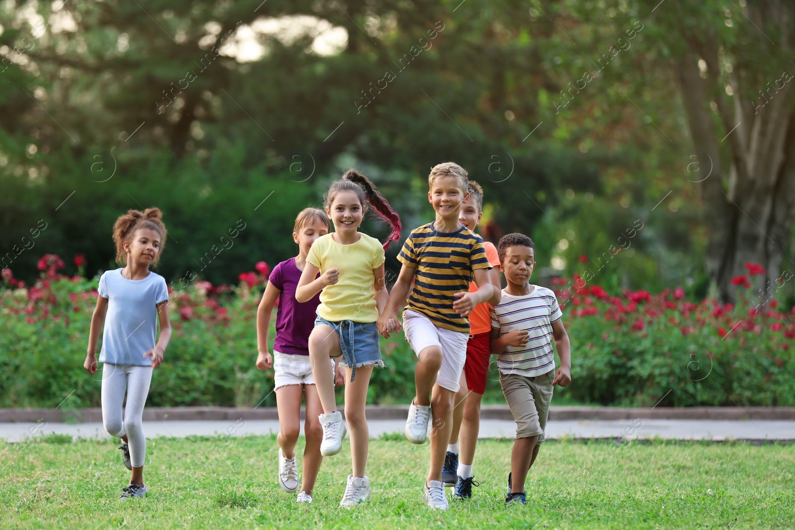 Photo of Cute smiling little children playing in park