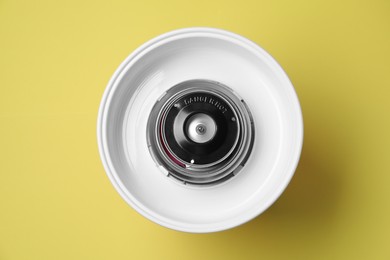 Photo of Portable candy cotton machine on yellow background, top view