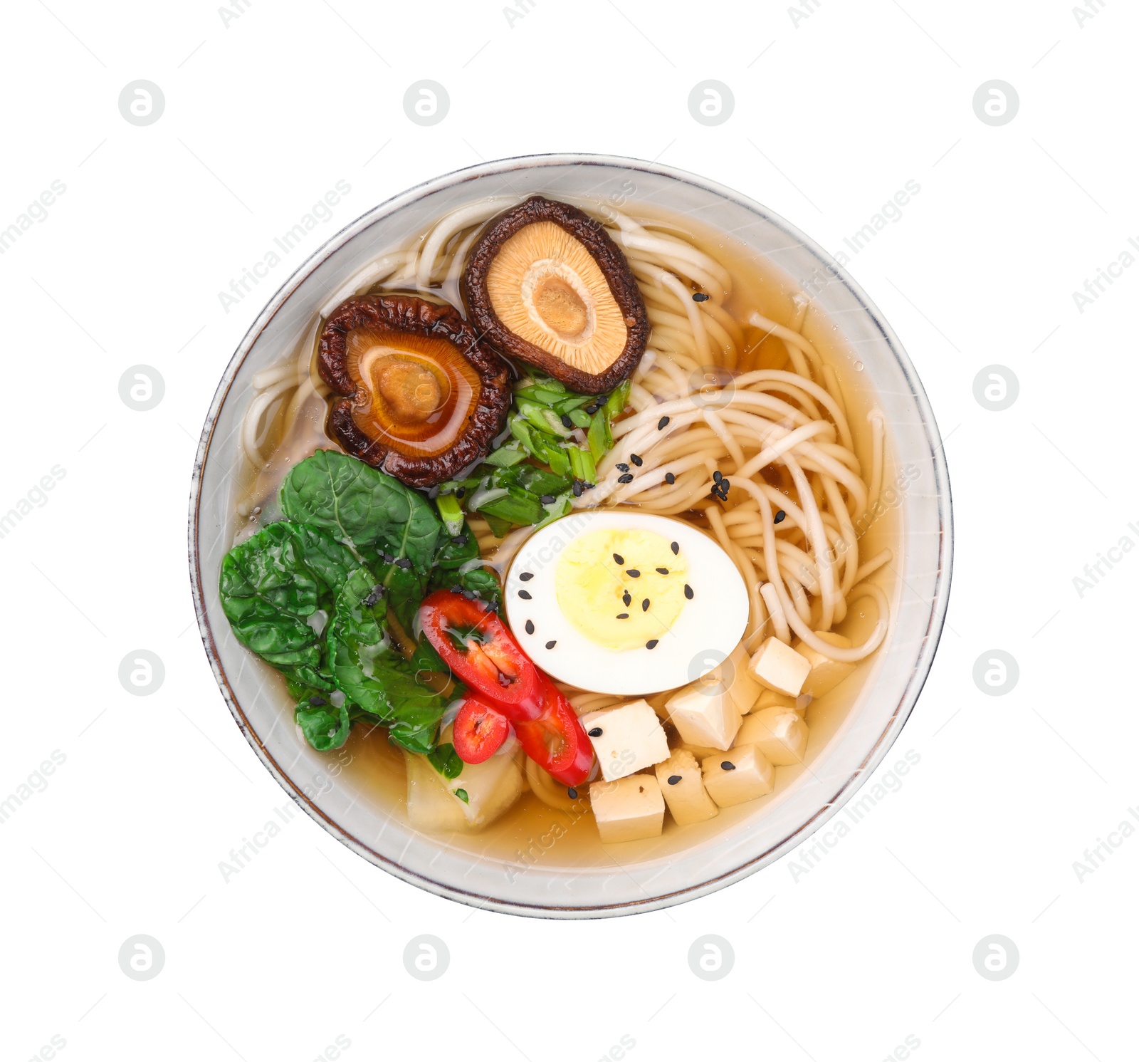 Photo of Delicious vegetarian ramen with egg, mushrooms, tofu and vegetables in bowl isolated on white, top view. Noodle soup