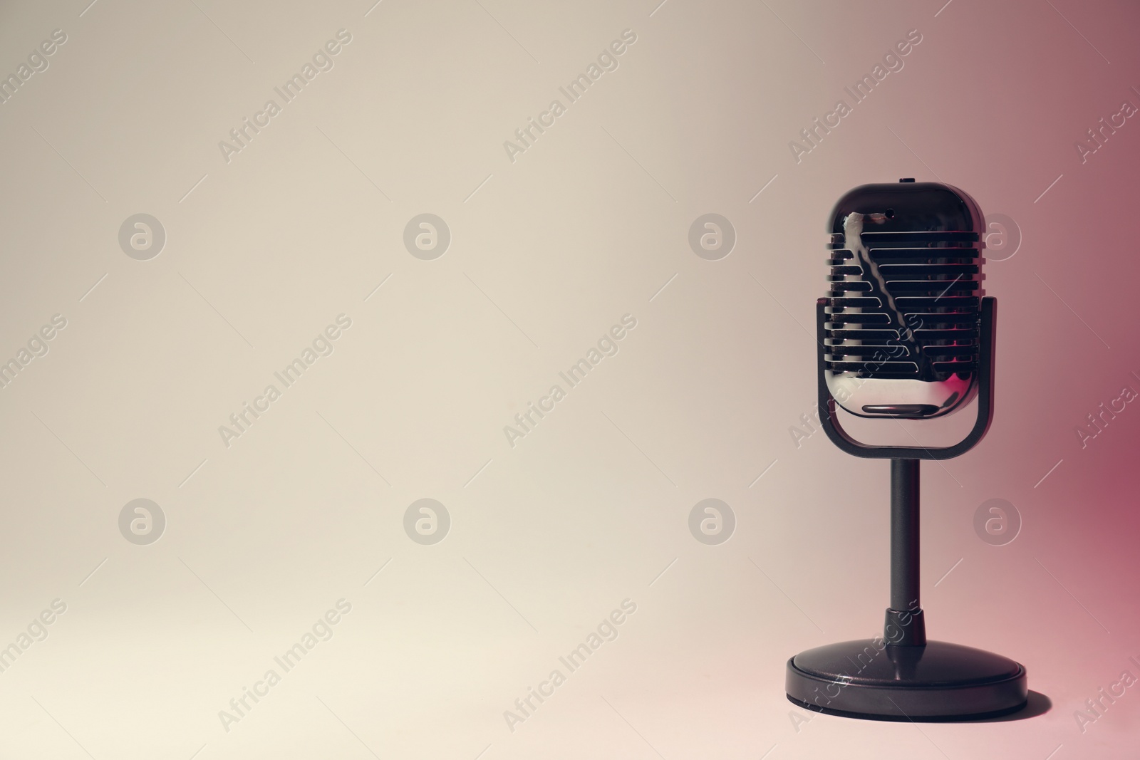 Photo of Retro microphone on color background. Space for text