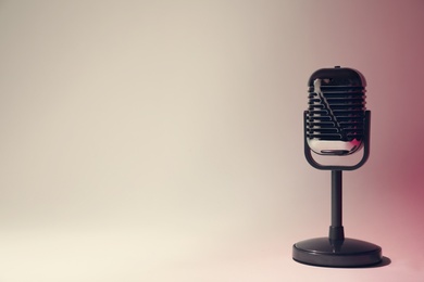 Photo of Retro microphone on color background. Space for text