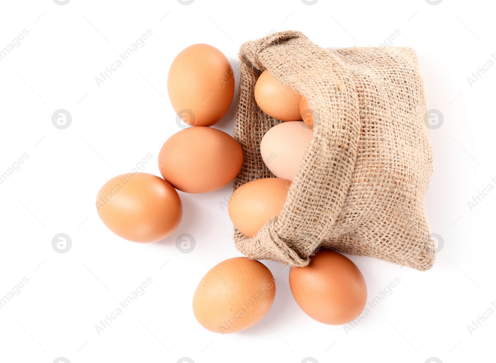 Photo of Fresh chicken eggs in burlap sack isolated on white, top view