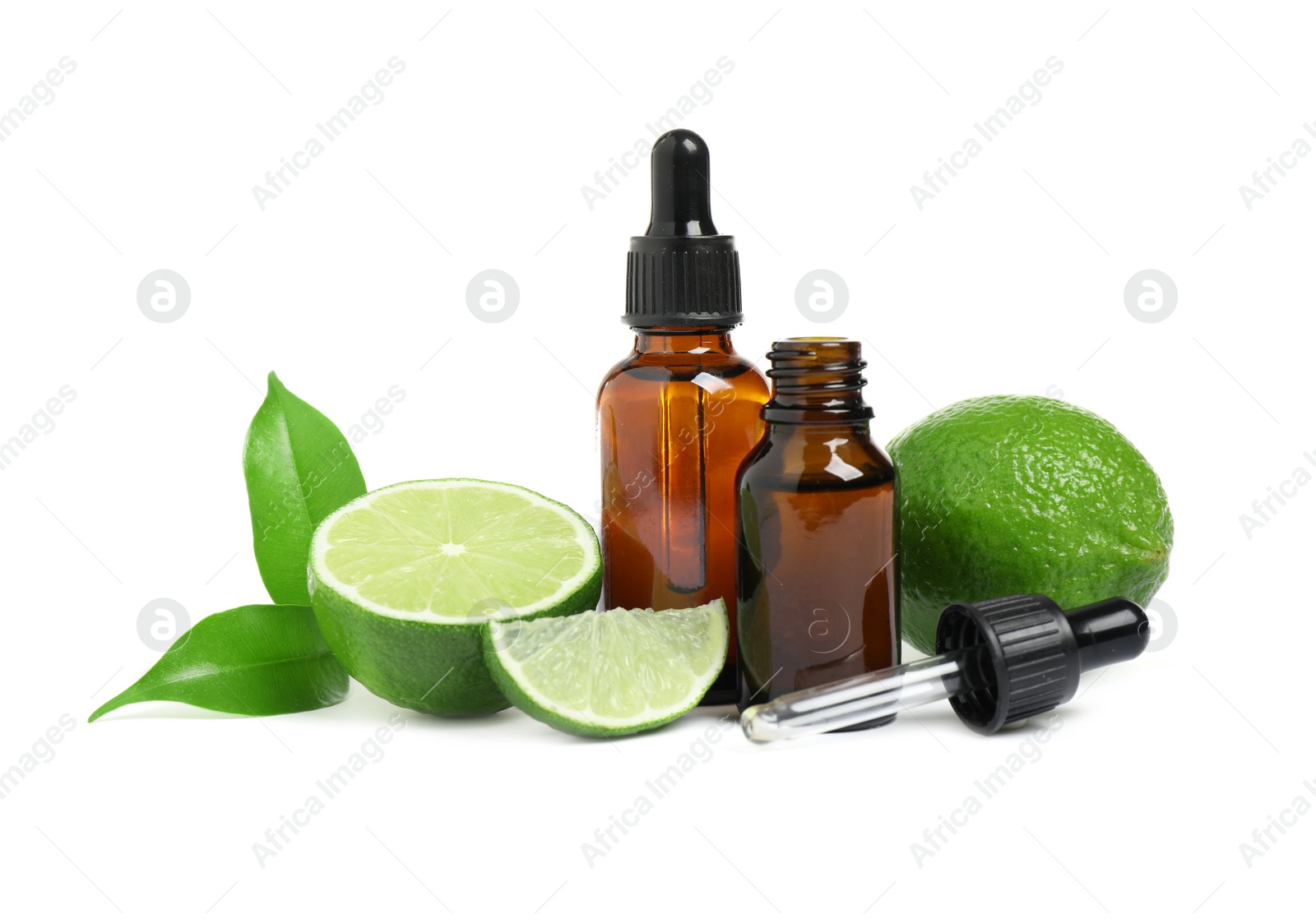 Photo of Lime essential oil in bottles and citrus fruits isolated on white