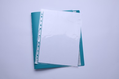 File folder with punched pockets and paper sheets isolated on white, top view