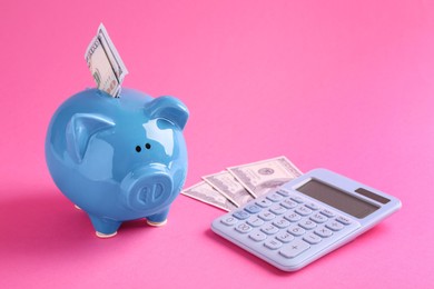 Photo of Financial savings. Piggy bank, dollar banknotes and calculator on pink background