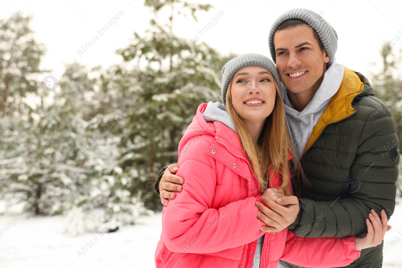 Photo of Beautiful happy couple in snowy forest on winter day