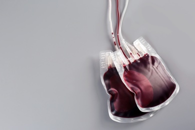 Photo of Blood packs on gray background, top view with space for text. Donation day