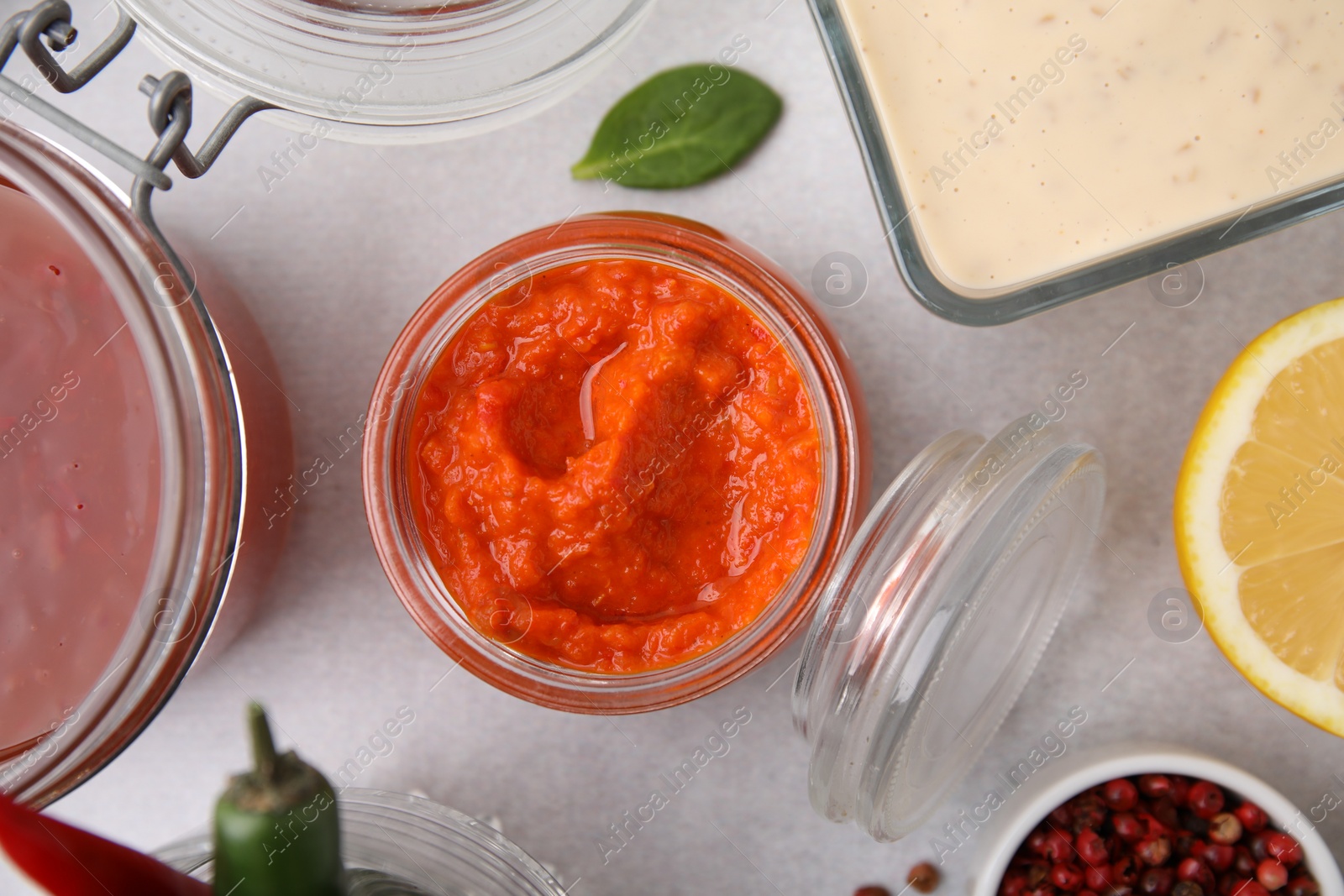 Photo of Different marinades on light table, flat lay