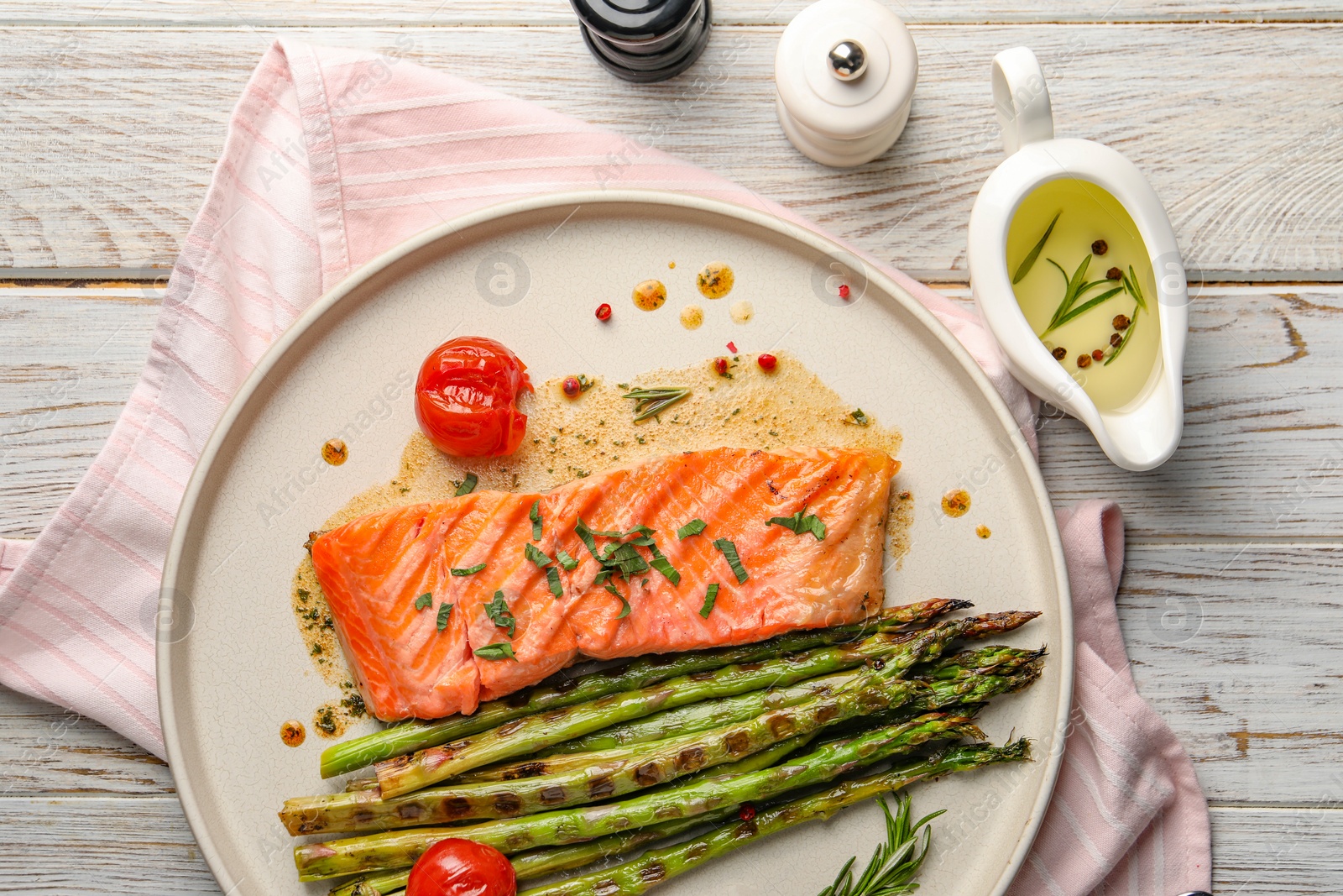 Photo of Tasty grilled salmon with tomatoes, asparagus and spices on table, flat lay