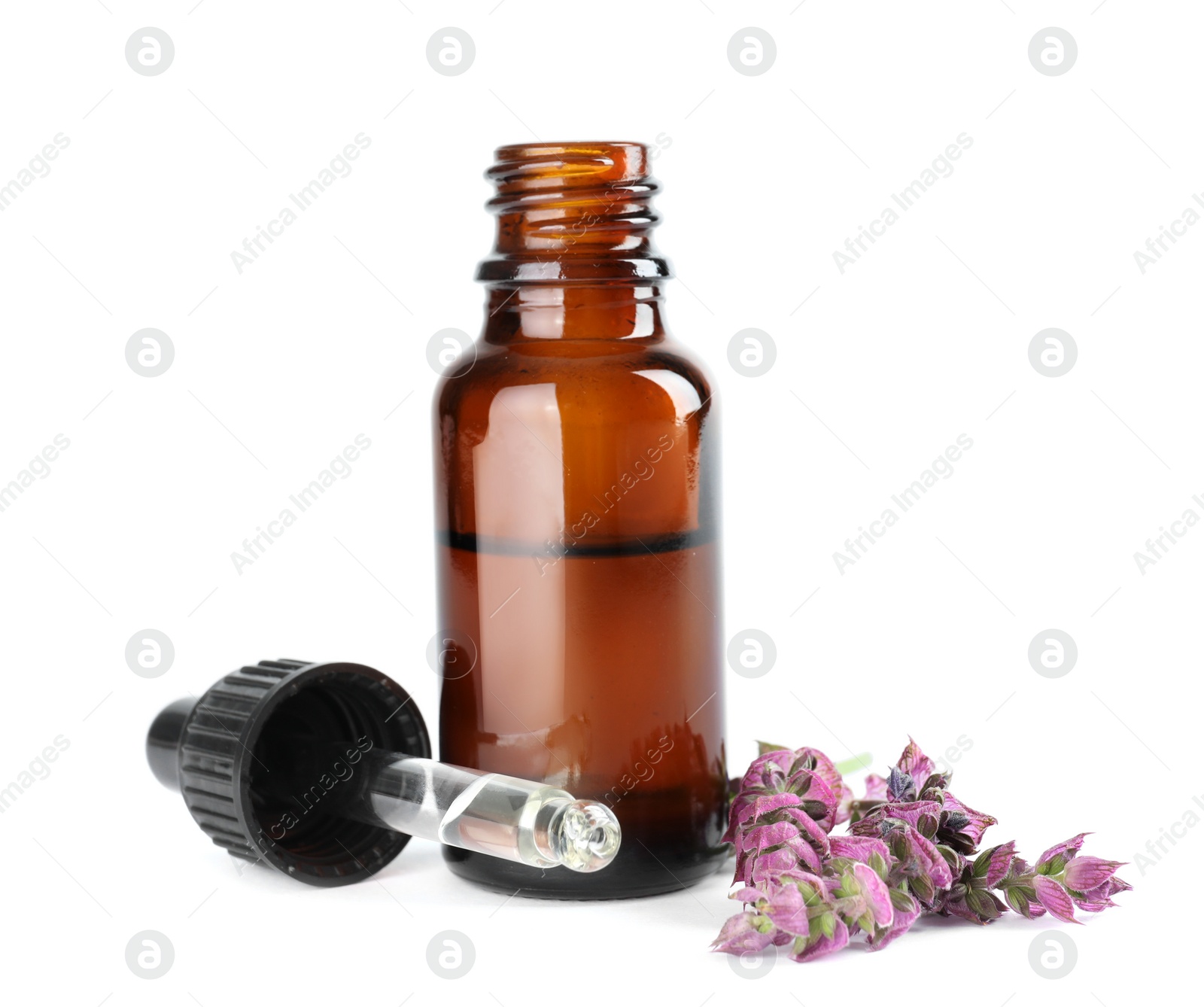 Photo of Bottle of herbal essential oil, pipette and sage flowers isolated on white