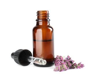 Bottle of herbal essential oil, pipette and sage flowers isolated on white