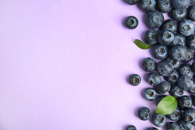 Fresh ripe blueberries on lilac background, flat lay. Space for text