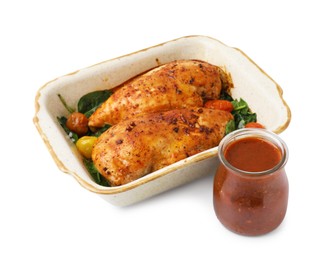 Baked chicken fillets with vegetables and marinade isolated on white