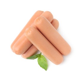 Photo of Delicious boiled sausages and basil on white background, top view