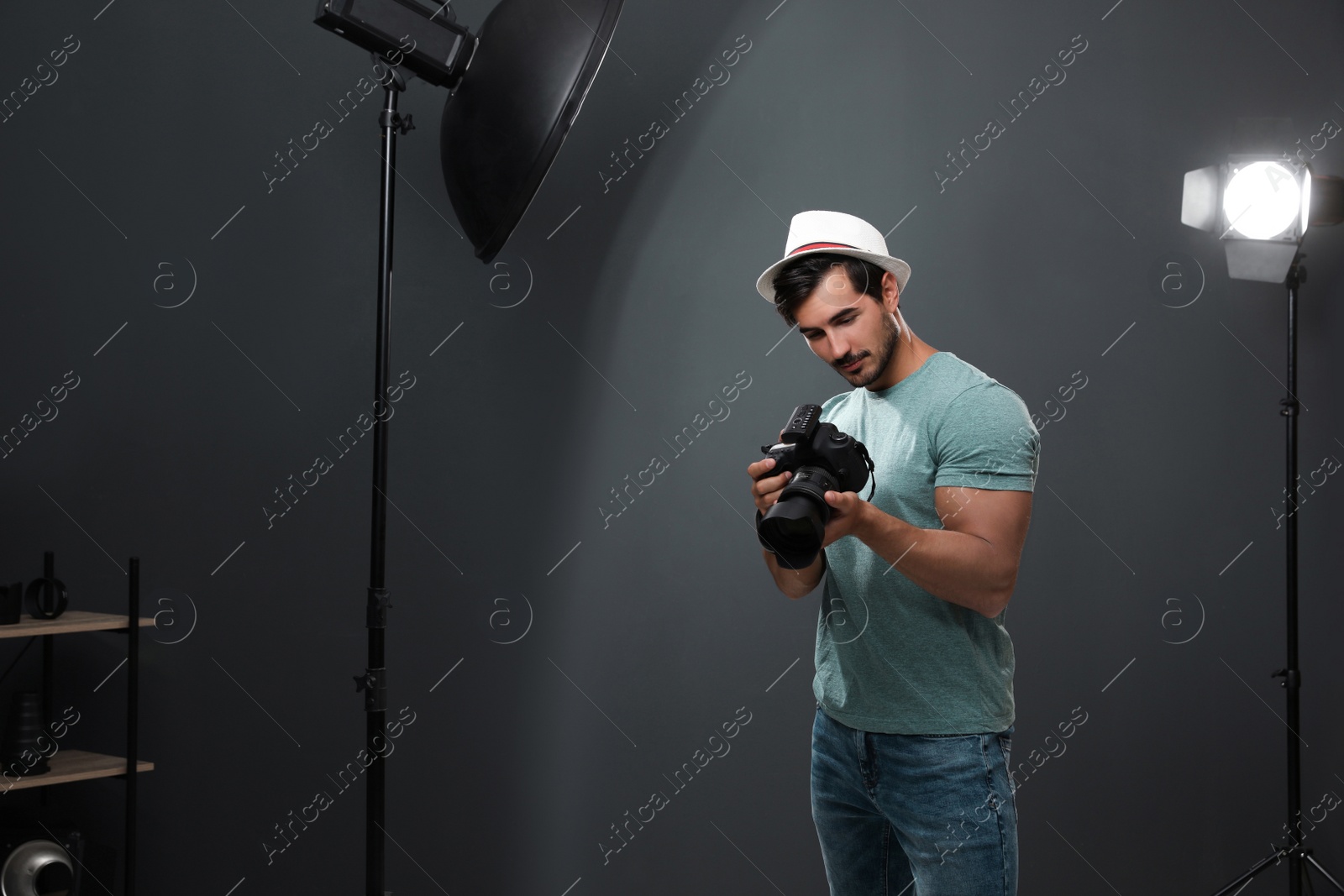 Photo of Professional photographer with modern camera in studio