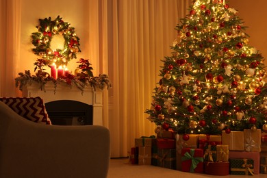 Beautiful Christmas tree and gifts near fireplace in festively decorated living room