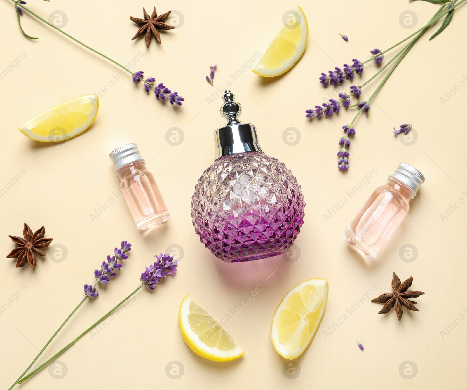 Photo of Flat lay composition with elegant perfume on beige background