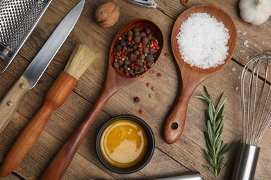 Photo of Flat lay composition with cooking utensils and ingredients on wooden table
