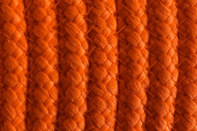 Photo of Texture of orange wicker mat as background, top view