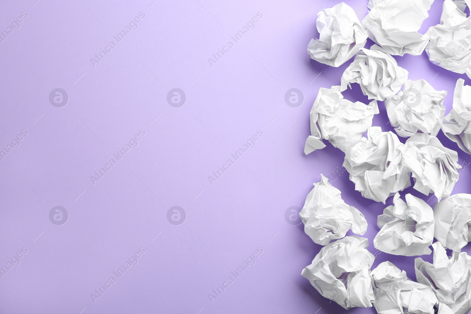 Photo of Crumpled sheets of paper on lilac background, flat lay. Space for text
