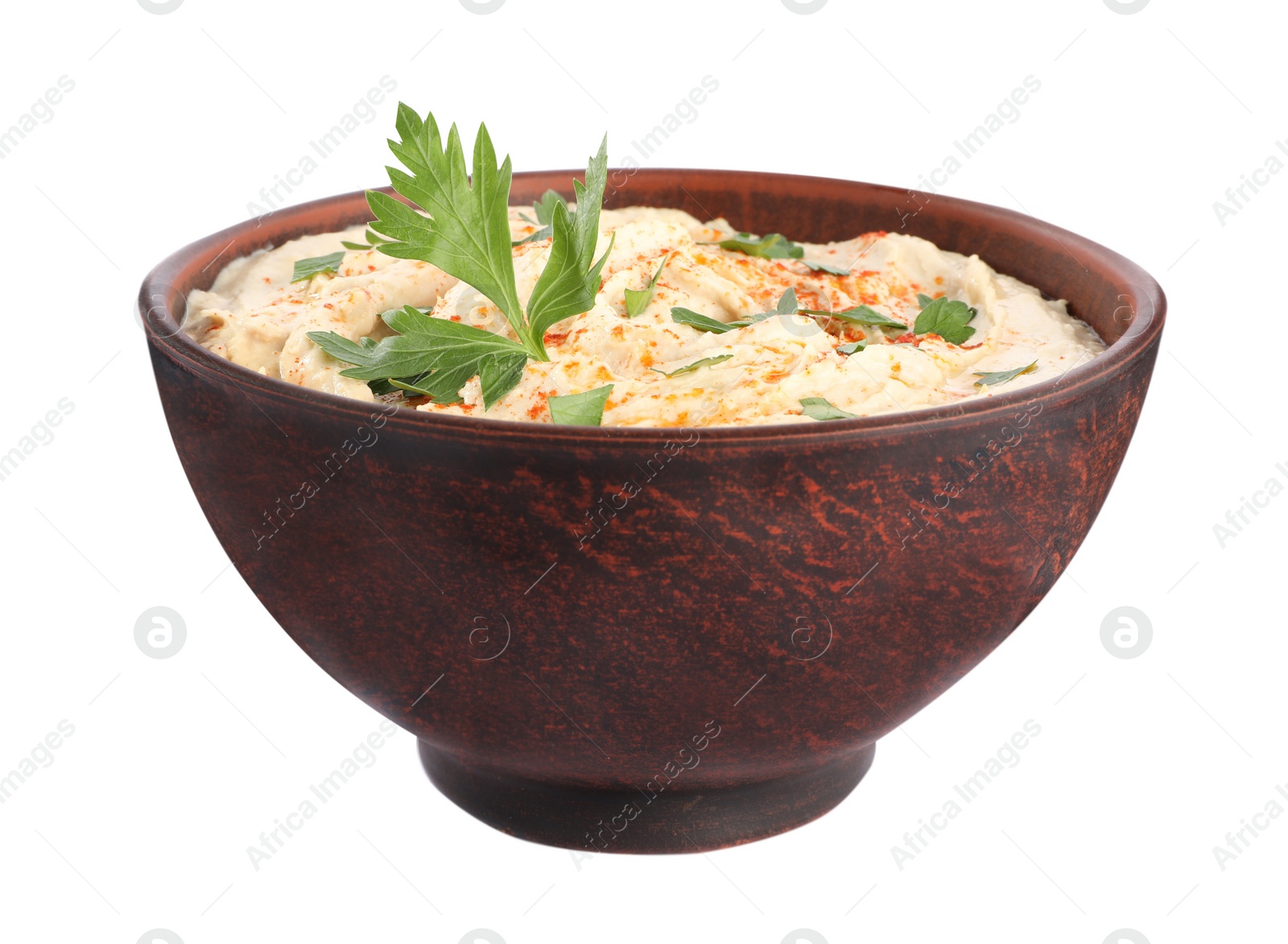 Tasty hummus with parsley and paprika in brown bowl isolated on white Photo of Tasty hummus with parsley and paprika in brown bowl isolated on white