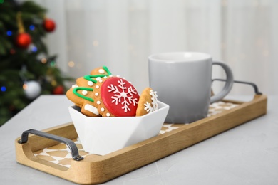 Photo of Tray with tasty homemade Christmas cookies and cup of coffee on table