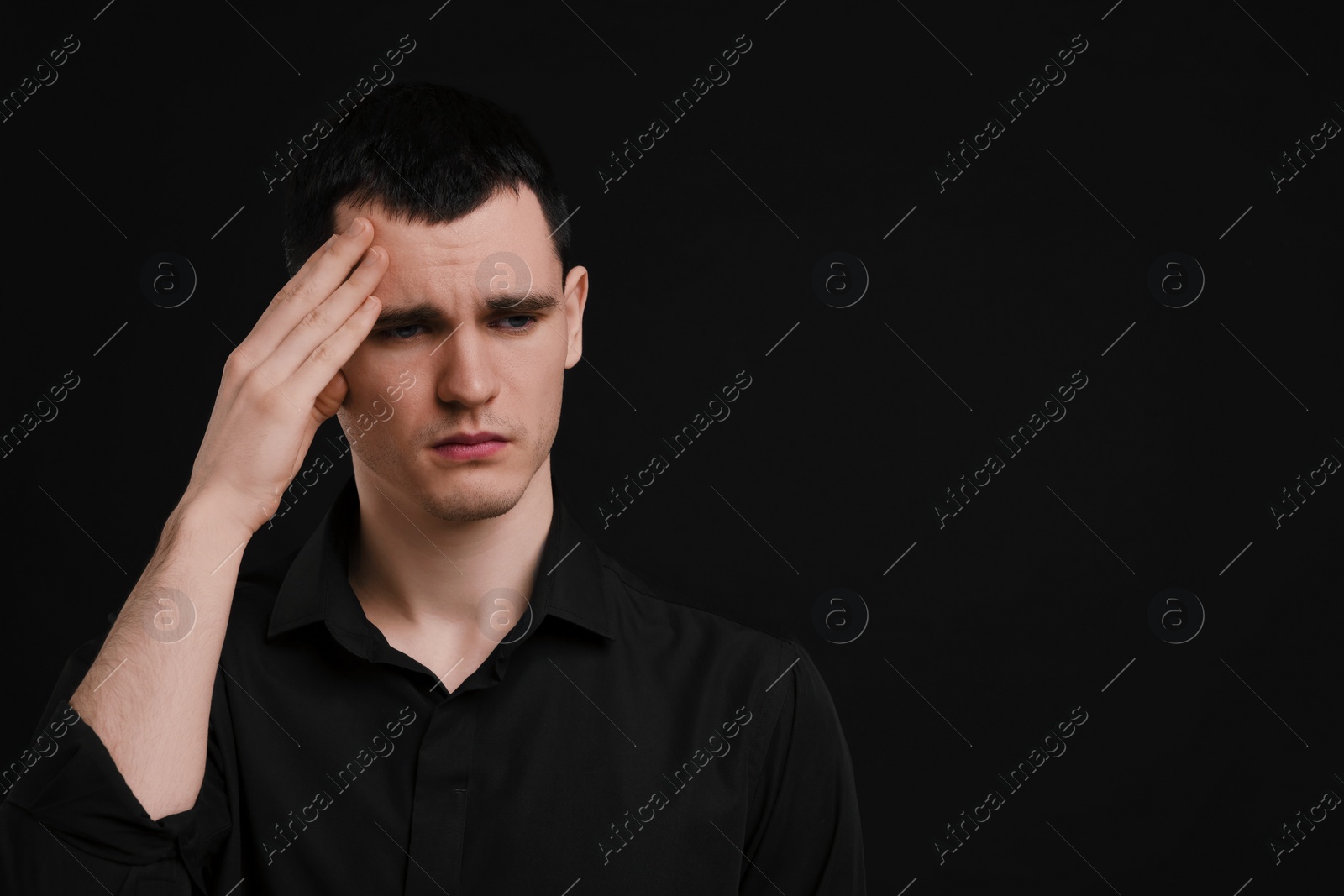 Photo of Portrait of sad man on black background, space for text