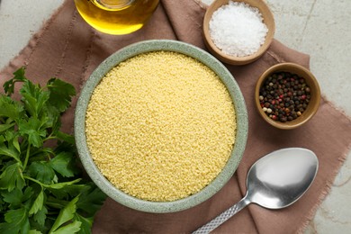 Photo of Raw couscous and ingredients on light table, flat lay