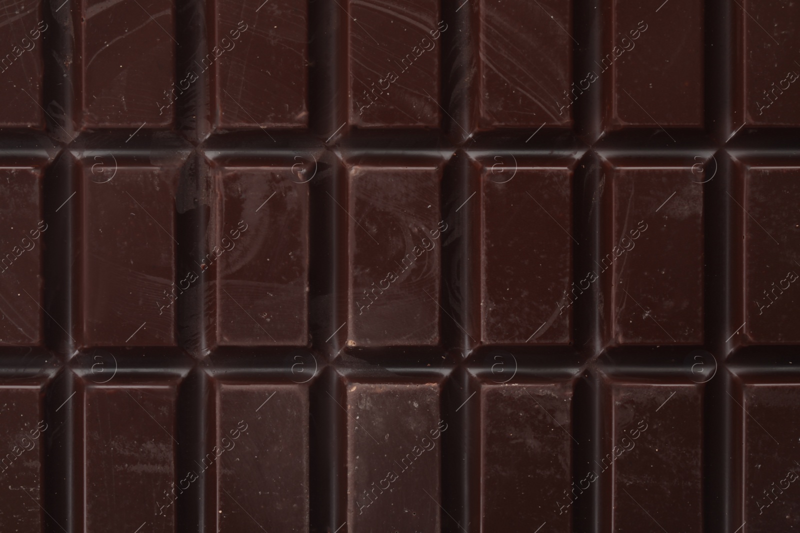 Photo of Delicious dark chocolate as background, closeup view