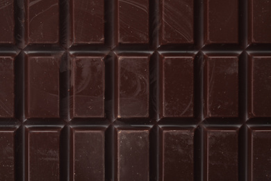 Photo of Delicious dark chocolate as background, closeup view