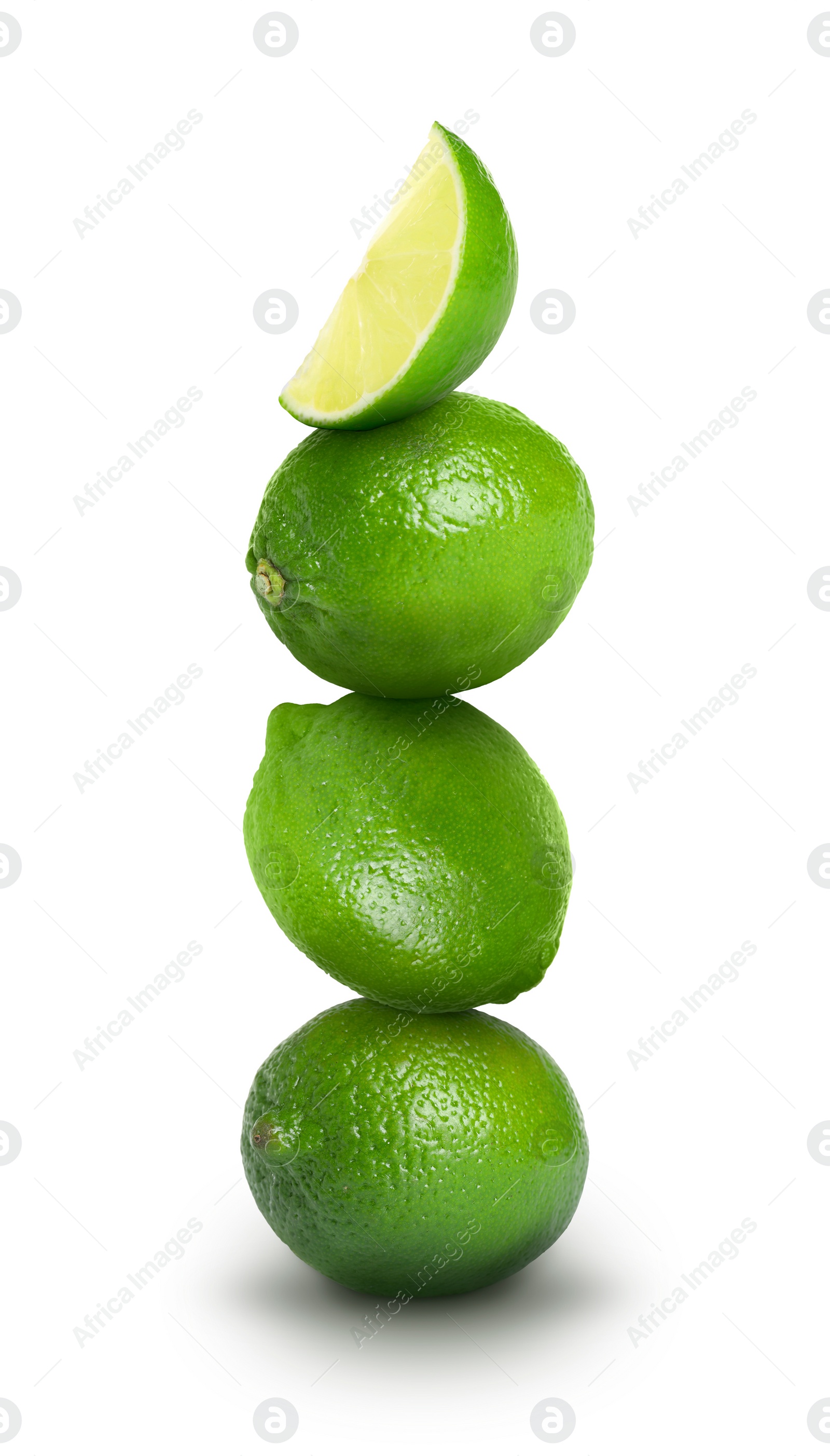 Image of Stacked whole and cut limes on white background