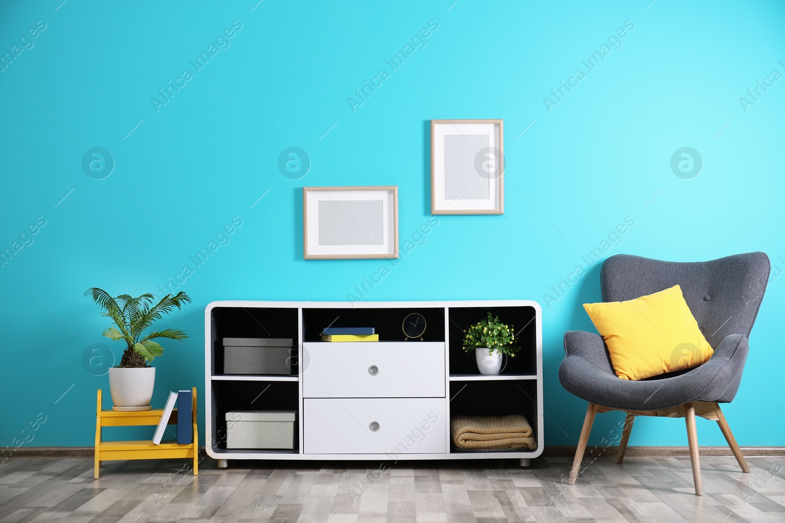 Photo of Elegant room interior with stylish shelving unit and armchair