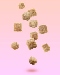 Image of Brown cane sugar cubes falling on color gradient background