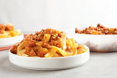 Photo of Plate with delicious pasta bolognese on table