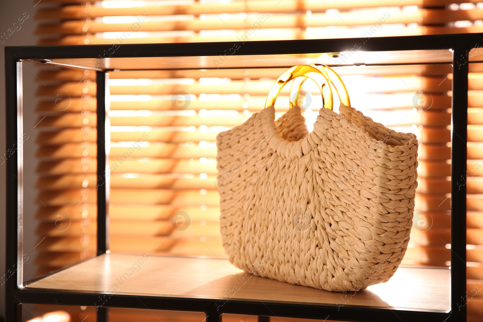 Photo of Stylish woman's bag on shelf in boutique