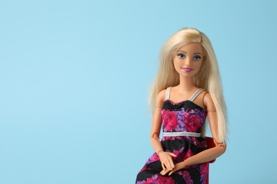 Photo of Mykolaiv, Ukraine - September 4, 2023: Beautiful Barbie doll on light blue background, space for text