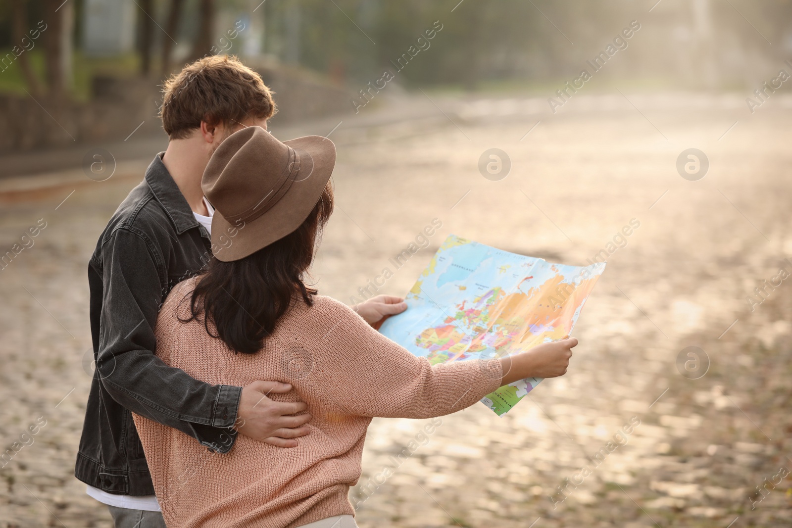 Photo of Couple of travelers with map on city street