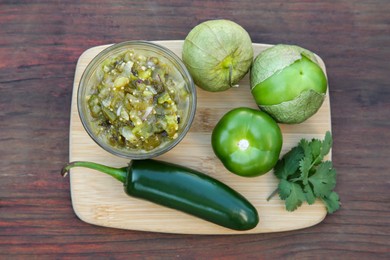 Tasty salsa sauce and ingredients on wooden table, top view