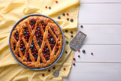 Photo of Delicious currant pie and fresh berries on white wooden table, flat lay